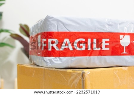 careful package for sending with fragile sticker warning