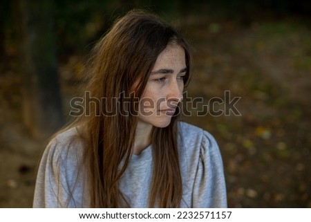 sad woman looking at her side Royalty-Free Stock Photo #2232571157