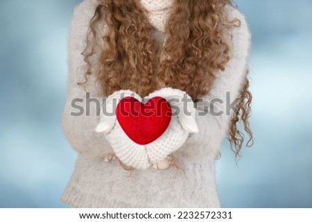 Woman hands hold a Read heart