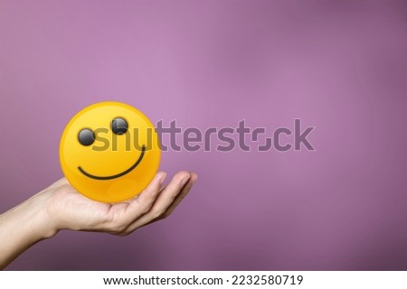 Hand of person Holding big Smiling icon.