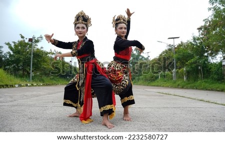 Two jaipong groups demonstrated graceful dance movements. Using a kebaya costume with unique knick-knacks and ornaments. Jaipong dance is a regional dance from West Java. Indonesia's cultural wealth.  Royalty-Free Stock Photo #2232580727