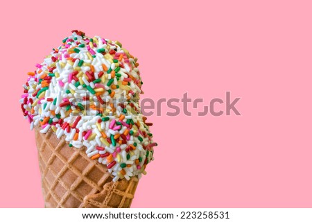 Ice Cream Scoops with Colored Sprinkles in a Waffle Cone on a Light Pink Background
