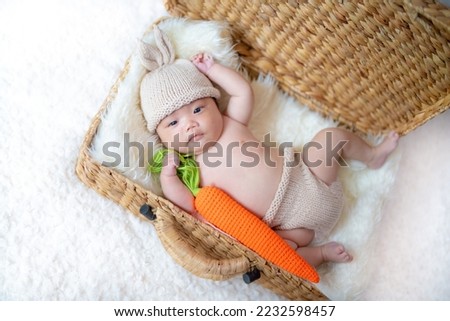 2 month old baby wearing bunny clothes
