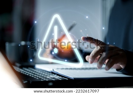 Businessman using computer laptop with triangle caution warning sing for notification error and maintenance concept. Royalty-Free Stock Photo #2232617097