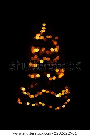 abstract christmas tree lights. Blurred golden lights on black background
