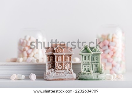 Merry Christmas decoration concept with candles and festive decor, colorful marshmallows, christmas trees on light white background. Cozy home. Space for text.