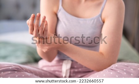 woman suffering her ache from wrist pain, numbness, or hand holding 