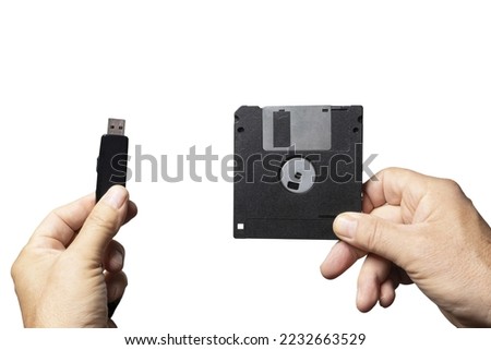 the comparison between an old floppy disk and a USB key for data storage