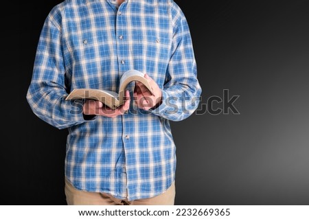 Christian person's hands with holy Bible book