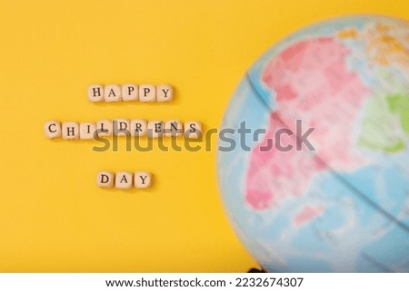 Universal children's day, inscription children's day on a yellow background, with a globe.