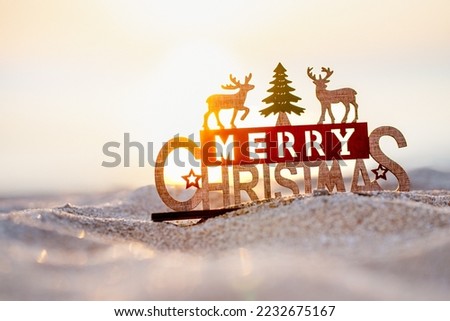 Beautiful light of sunset beach with wooden Merry Christmas word, Christmas banner, happy concept, copy space, soft focus
