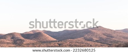 Aerial view of mountain hills, a mountain background with a copy space - the concept of tourism and travel. Beautiful panoramic landscape of mountain peaks. 