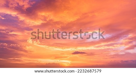 Sunset Sky in the Evening with Orange, yellow sunlight on Golden hour sky, Dramatic storm Clouds background  Royalty-Free Stock Photo #2232687579