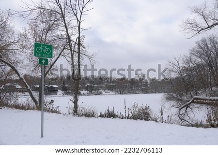 selective focus, A green bike route sign on the side of the path, landscape background