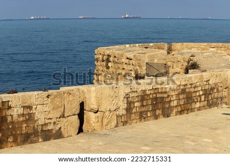 Stone wall of an ancient fortress on the seashore in Israel.