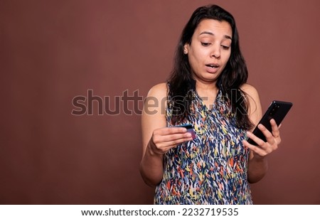 Indian woman buying product in online store, holding smartphone and credit card. Person making order in ecommerce website, searching goods in internet shop site, checkout concept