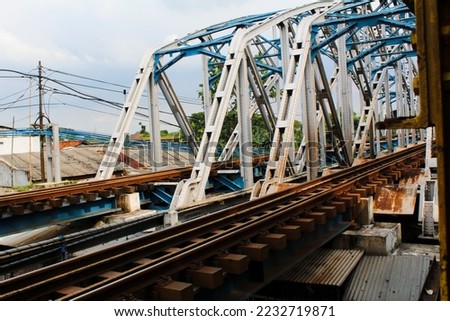 The blue sky railway bridge is centered in Karawang