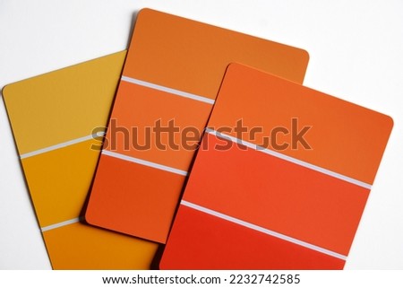 Color swatch samples on a desk. Light to dark shades of autumnal yellows and oranges. Fall color schemes. Interior design color pallet. Design concept. Creative inspiration.