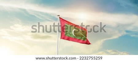 Maldive national flag waving in beautiful sky.