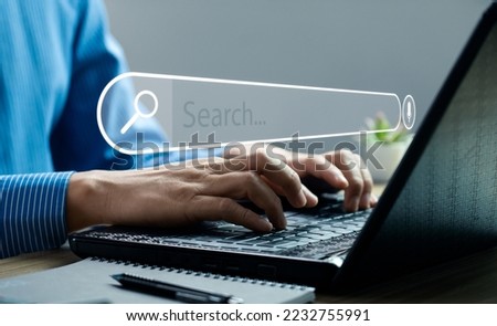 Businessman hand using laptop or computer to search information on internet social media web with search box icon and copy space. search engine information search technology
