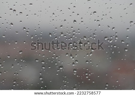Raindrops splash on the glass
