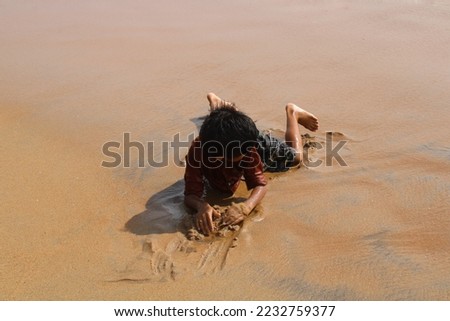 Little boy plays at a beach