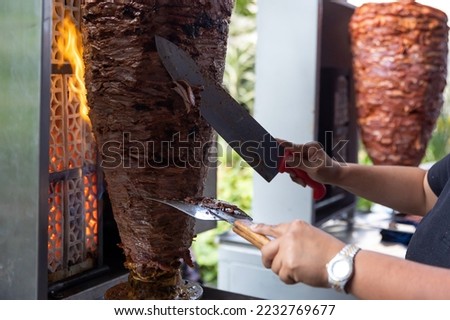close up of Mexican taquero cutting the pastor meat in the center of Mexico City