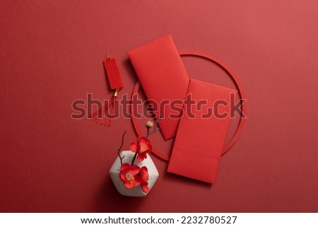 Top view of lucky envelopes and decorative items for Chinese lunar new year on red background. Space for text Royalty-Free Stock Photo #2232780527
