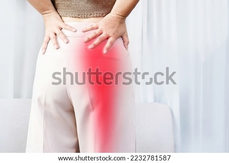 Sciatica Pain concept with woman suffering from buttock pain spreading to down leg 