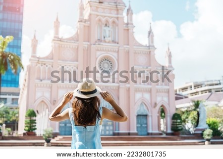Woman Traveler with blue dress visiting in Da Nang city. Tourist sightseeing the Da Nang Cathedral church. Landmark and popular for tourist attraction. Vietnam and Southeast Asia travel concept Royalty-Free Stock Photo #2232801735
