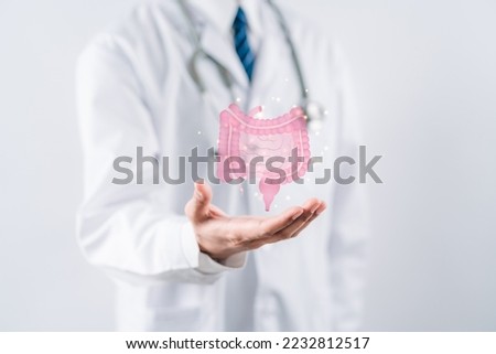 doctor in a white coat hands holding stomach with intestine virtual icon, probiotics food for gut health, colon cancer, bowel inflammatory. Health checkup concept. Royalty-Free Stock Photo #2232812517