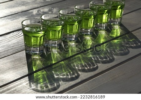 green absinthe drink pattern on the white wooden background with copy space