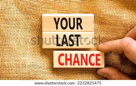Time to your last chance symbol. Concept words Your last chance on wooden blocks on a beautiful canvas table canvas background. Businessman hand. Business and your last chance concept. Copy space.