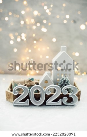 Christmas and New Year card. Number 2023 on holiday background. Christmas lights bokeh background. Holiday postcard. Happy New Year 2023 Card Concept Royalty-Free Stock Photo #2232828891