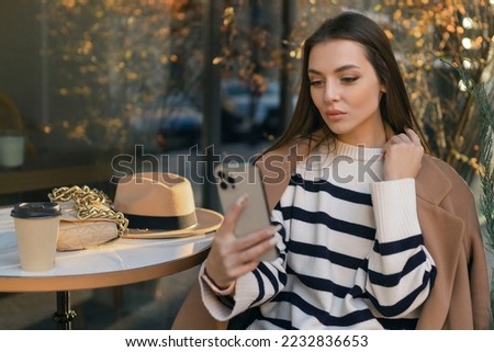 Happy woman in casual wear smiling, talking, walking, drinking coffee, chatting online, taking selfie using mobile phone alone
