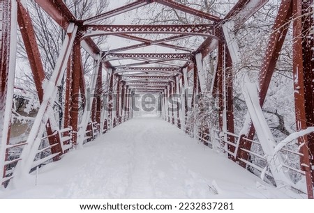 Intense snowfall in one of the most famous iron bridges of Torrejon de Ardoz (Madrid) after the passage of the snowstorm called Filomena, leaving everything frozen and snowy, a picture of postal
