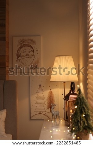 Beautiful Christmas pictures in decorated room. Interior design