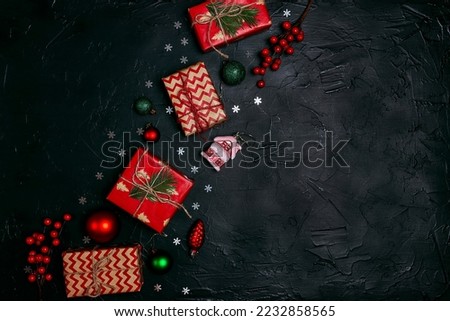Christmas black background with gifts and decorations. Flat lay festive border with copy space.
