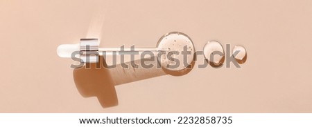 pipette drop of serum test on a beige background Royalty-Free Stock Photo #2232858735