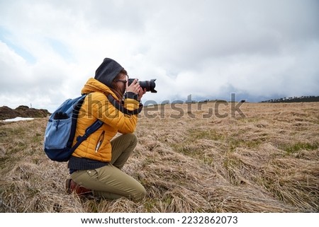 Young woman photographer enjoying in nature.