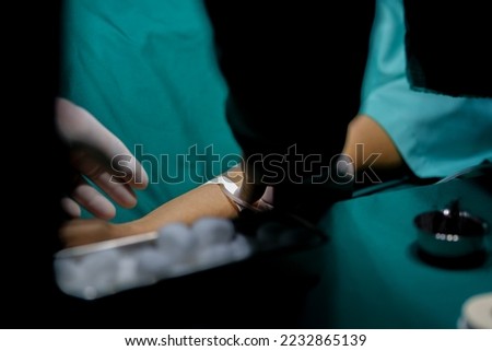 A nurse is preparing a patient before surgery being given saline solution.
