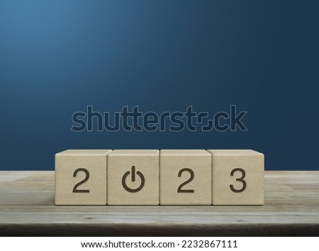 2023 start up business icon on wood block cubes on wooden table over light blue wall, Happy new year 2023 success concept