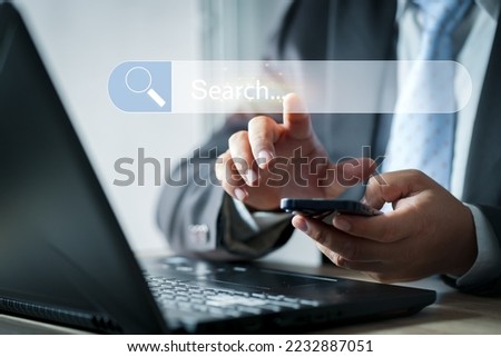Search button on virtual screen. Search engine optimization, SEO.Businesswoman using laptop searching Browsing Internet Data Information.Networking Concept.
