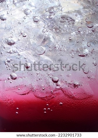 close up surface of glass of iced strawberry soda drink