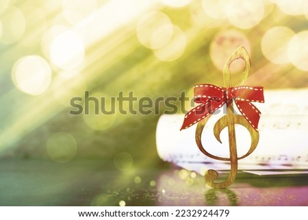 Wooden music note with red bow on table, space for text. Christmas music
