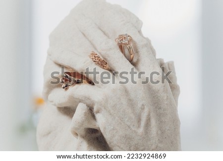 white figurines with wedding rings on close-up