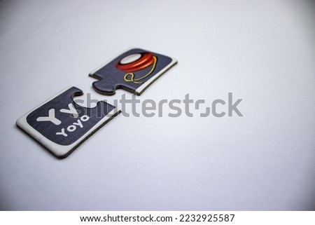 Two piece puzzle with letter y and red yoyo placed diagonally from left to middle of white background