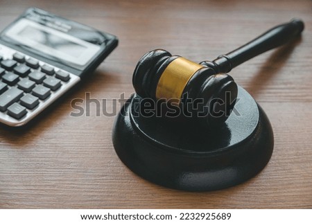 Law and finance. Bankcruptcy, tax law, bribe, corruption, arbitration, penalty concept.Gavel and calculator on a wooden background. Royalty-Free Stock Photo #2232925689