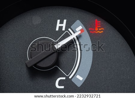 Needle pointer at the high temp point of the temperature gauge in the vehicle radiator and the symbol has the red light is on Royalty-Free Stock Photo #2232932721