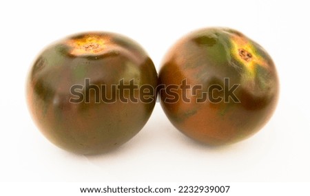 ripe black tomatoes on a white background